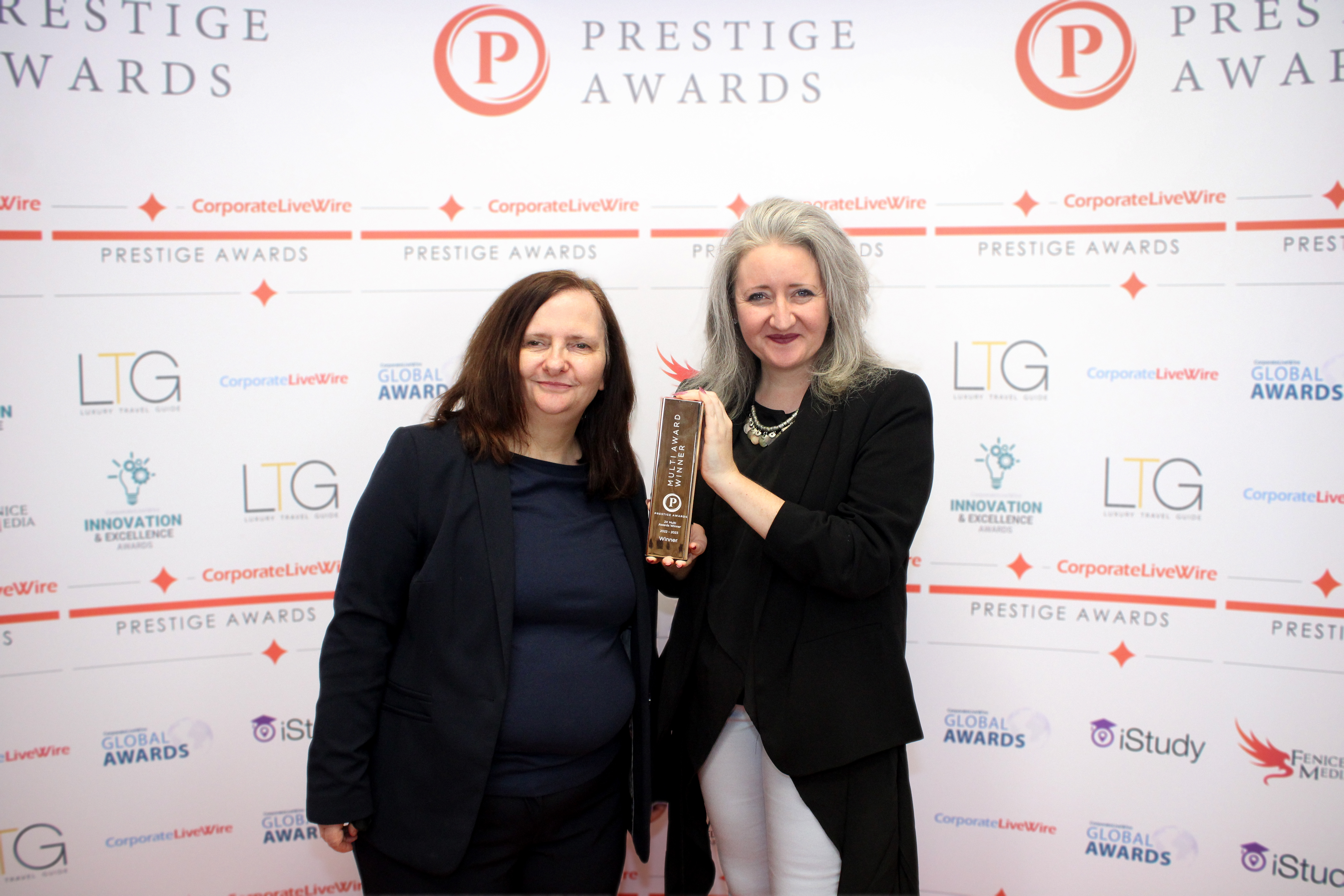 Sharon and Justine holding the Prestige Award